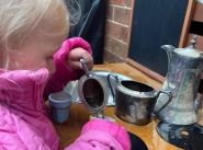 The joys of pouring pretend tea from Grandma's silverware