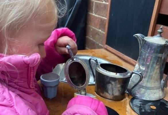 The joys of pouring pretend tea from Grandma's silverware