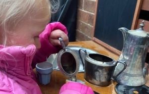 The joys of pouring pretend tea from Grandma's silverware